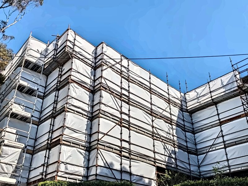 Scaffold with white Monaflex sheeting around a multi-level building in Bellevue Hill