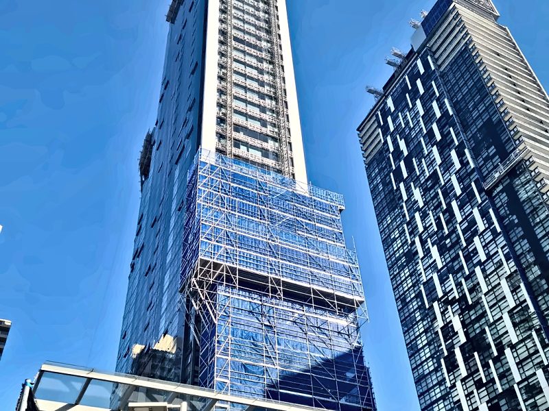 Blue-sheeted ATPAC scaffold wrapping the lower levels of a high-rise tower in Chatswood